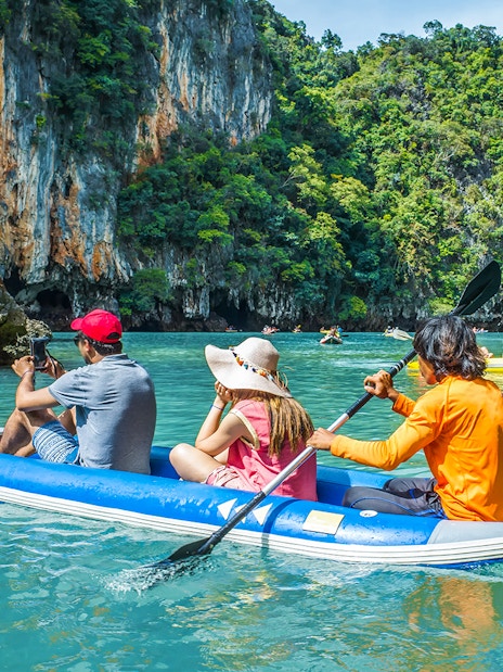 Canoeing through limestone cliffs on Phang Nga Bay during a guided tour to James Bond Island.