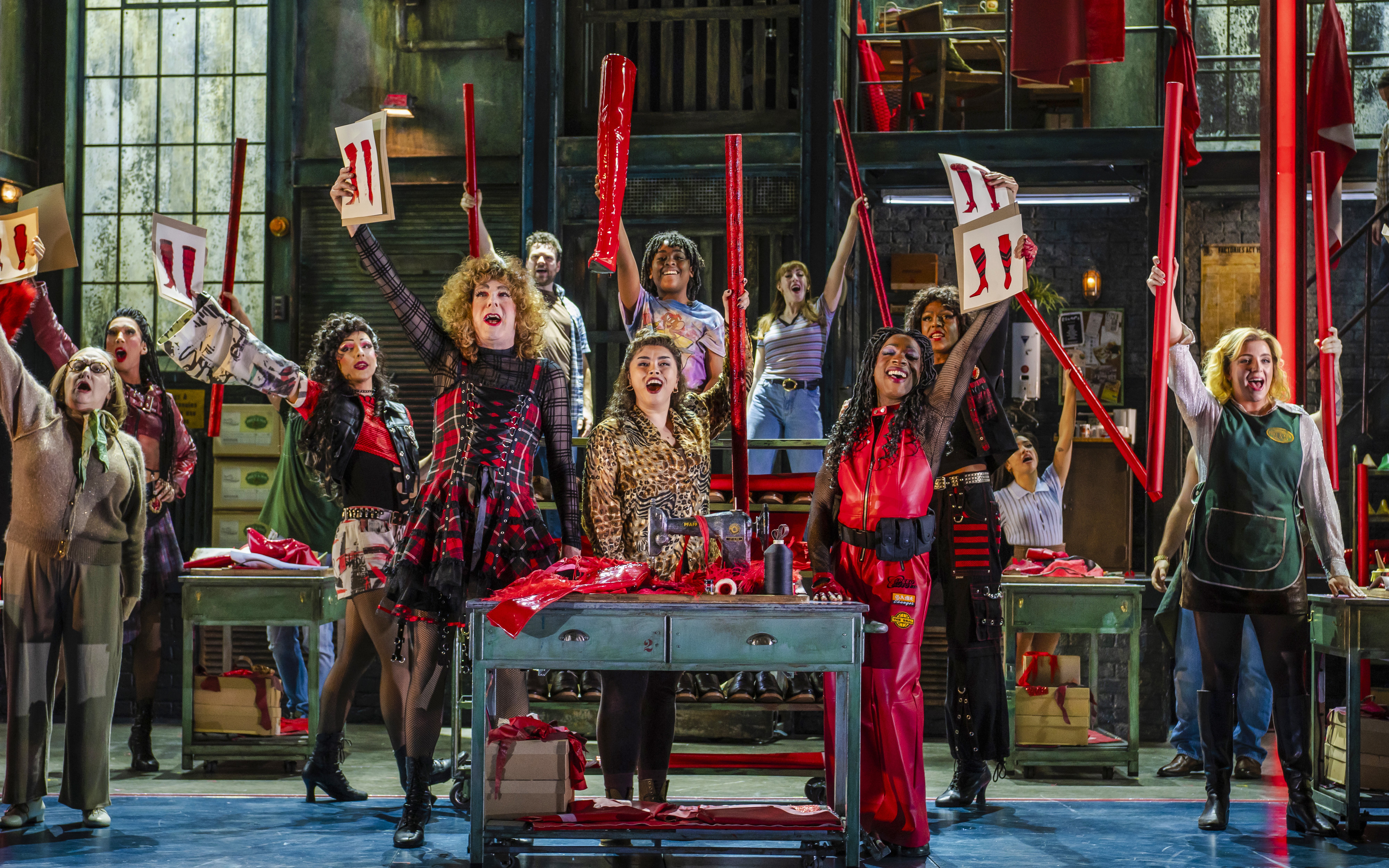 Performers on stage during a vibrant scene from the Kinky Boots musical production.