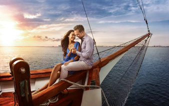 Couple enjoying a romantic sunset cruise on a boat in Cancun.
