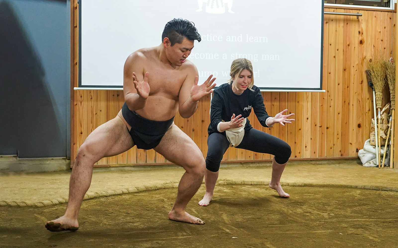 Sumo wrestler teaching a participant in a Tokyo sumo wrestling experience.