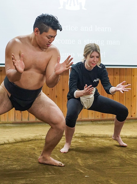 Sumo wrestler teaching a participant in a Tokyo sumo wrestling experience.