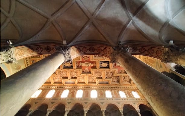 Ceiling of Basilica in Catacombs of Saint Agnes, Rome with ornate columns and detailed artwork.