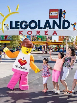 Family enjoying with LEGO character at LEGOLAND Korea entrance.