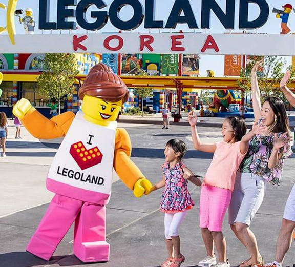 Family enjoying with LEGO character at LEGOLAND Korea entrance.