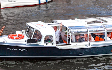 Boat tour with passengers enjoying a Cheese & Wine Cruise through Haarlem canals.