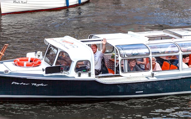 Boat tour with passengers enjoying a Cheese & Wine Cruise through Haarlem canals.
