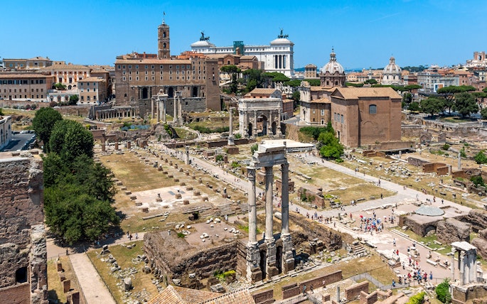 Palatine Hill view of Roman Forum ruins in Rome, Italy, with ancient columns and historic buildings.