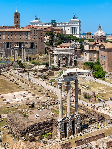 Palatine Hill view of Roman Forum ruins in Rome, Italy, with ancient columns and historic buildings.