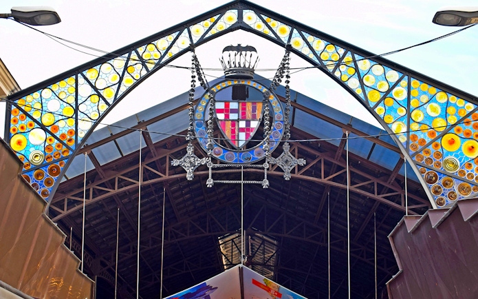 Entrance of La Boquería market with colorful stained glass, Barcelona Markets Walking Tour.