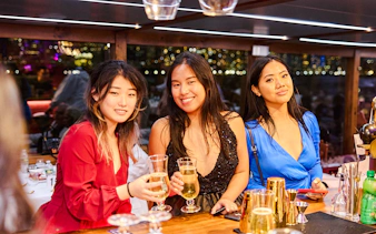 Guests enjoying drinks on New Year's Eve dinner cruise.