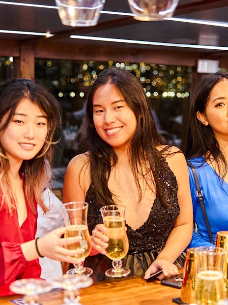 Guests enjoying drinks on New Year's Eve dinner cruise.