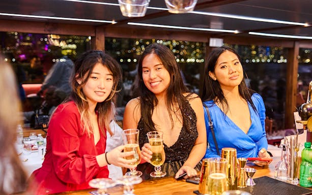 Guests enjoying drinks on New Year's Eve dinner cruise.