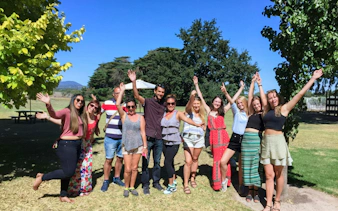 Group enjoying Yarra Valley Wine tour under clear blue sky.