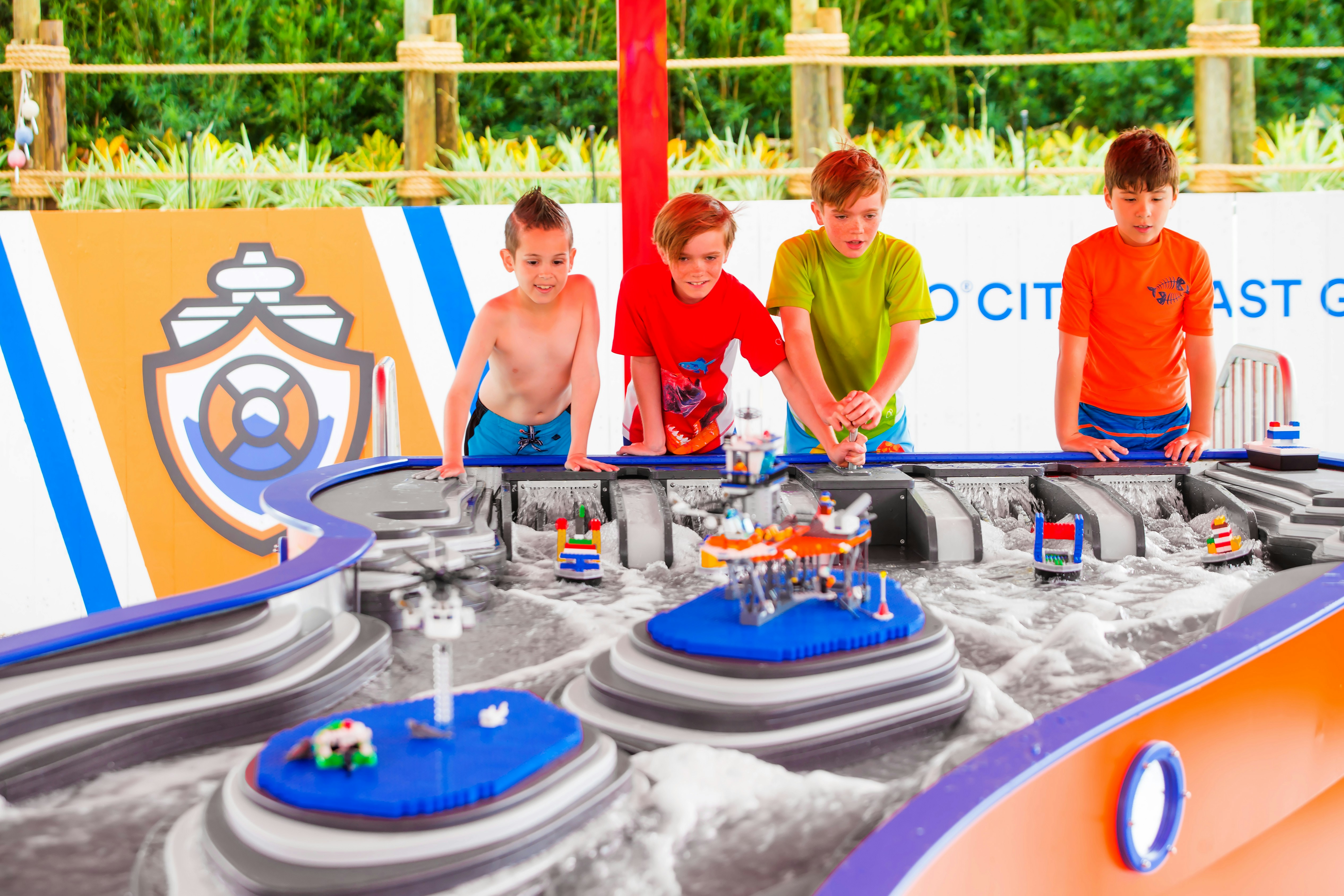 Children building boats at Legoland Water Park interactive water table.