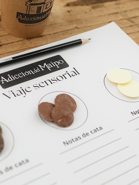 Tasting notes sheet with chocolate samples during El Yeso Reservoir & Santuario del Río Spa tour.