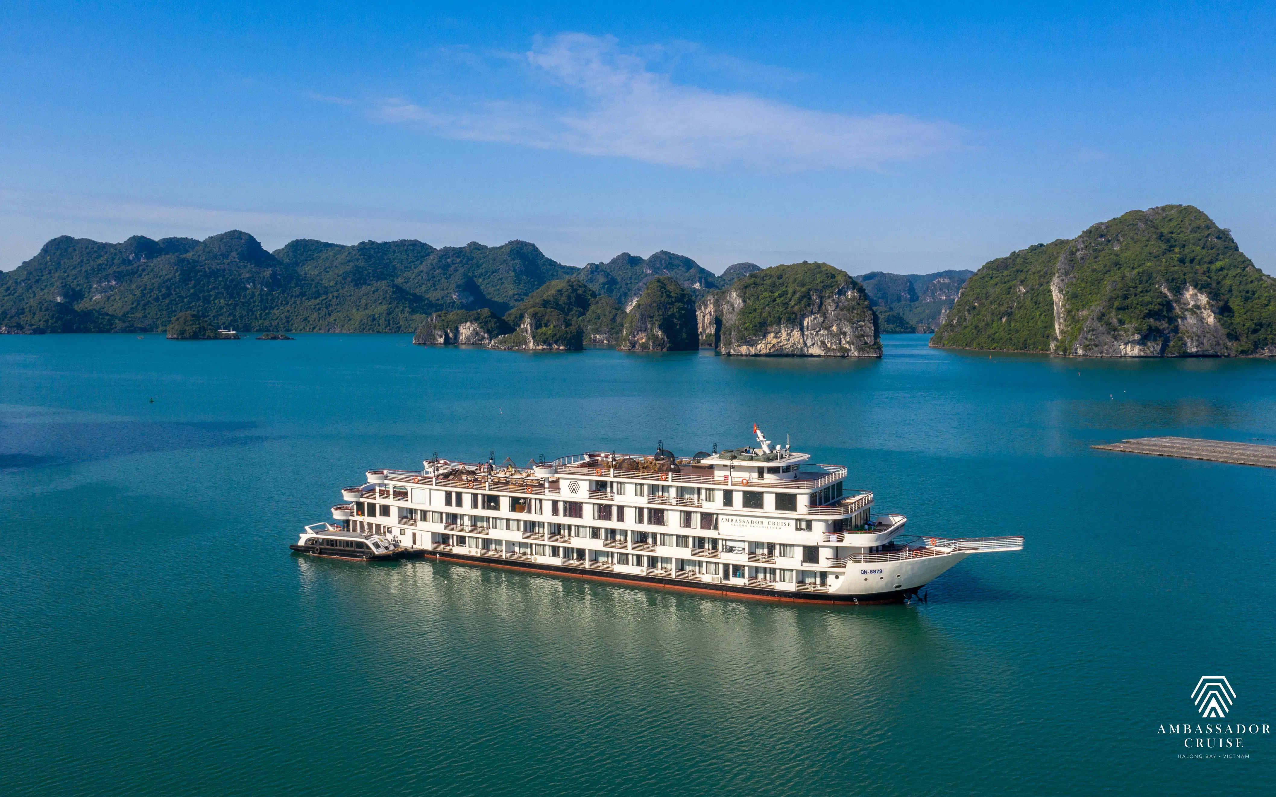 Luxury cruise ship in Ha Long Bay, Vietnam, surrounded by limestone islands.