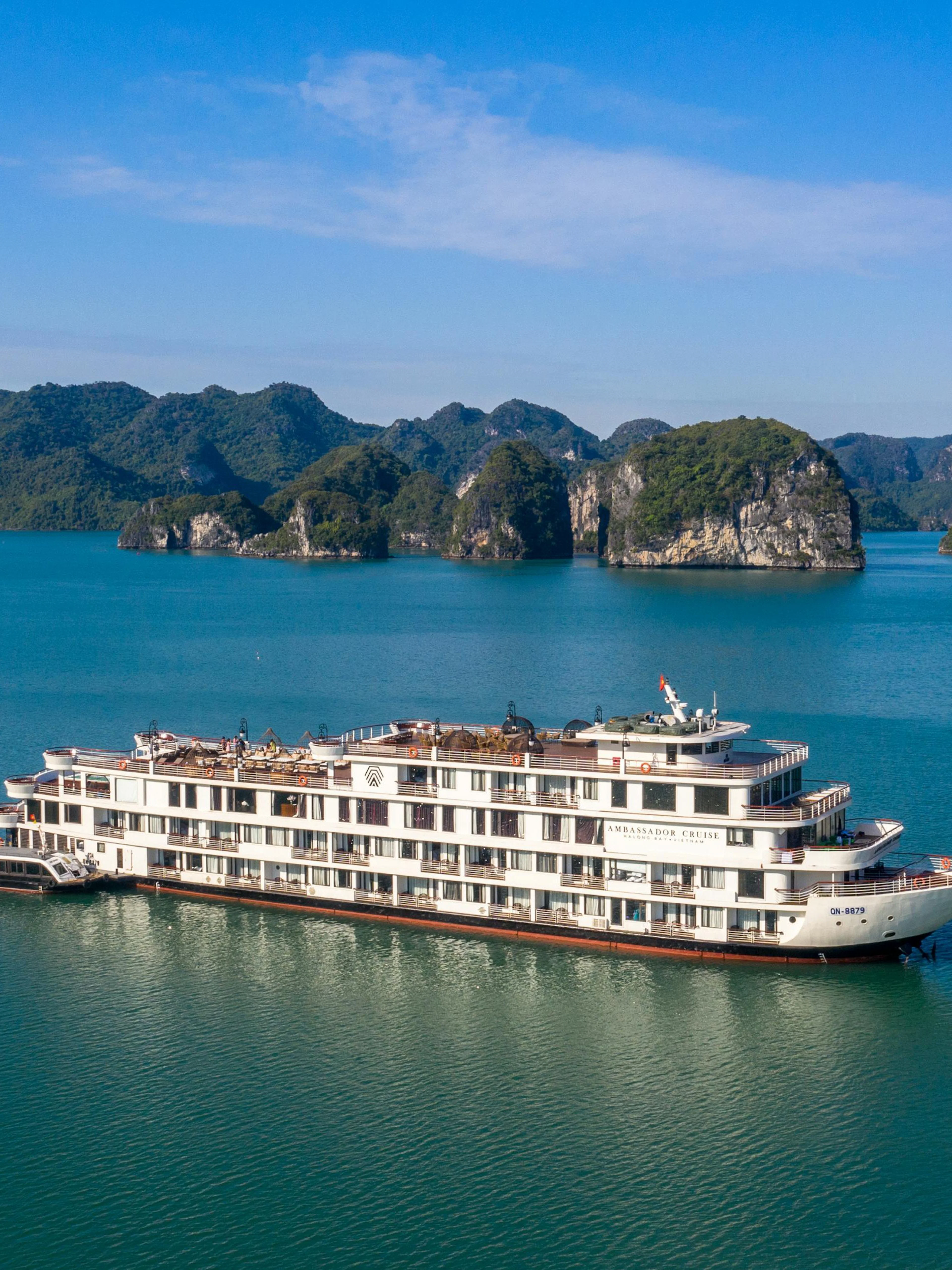 Luxury cruise ship in Ha Long Bay, Vietnam, surrounded by limestone islands.
