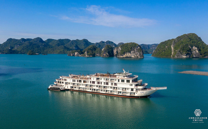 Luxury cruise ship in Ha Long Bay, Vietnam, surrounded by limestone islands.