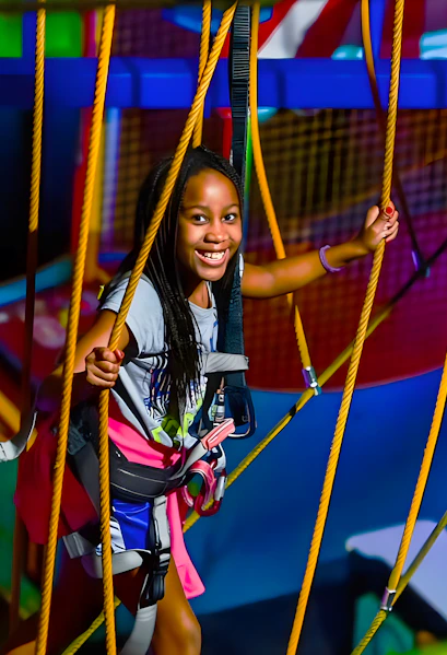 Child navigating ropes course at WonderWorks, Orlando theme park.