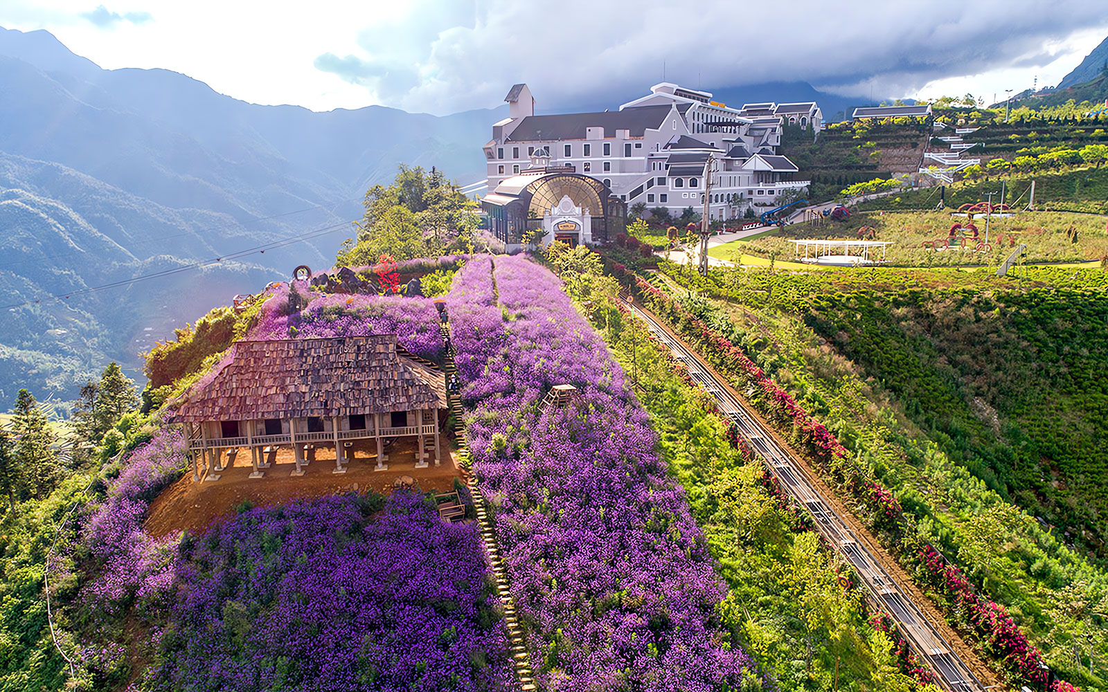 Sun World Fansipan Cable Car station with Muong Hoa Monorail and purple flower fields in Sapa, Vietnam.