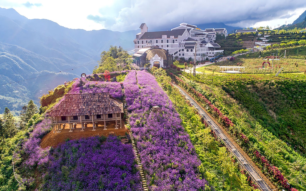 Sun World Fansipan Cable Car station with Muong Hoa Monorail and purple flower fields in Sapa, Vietnam.