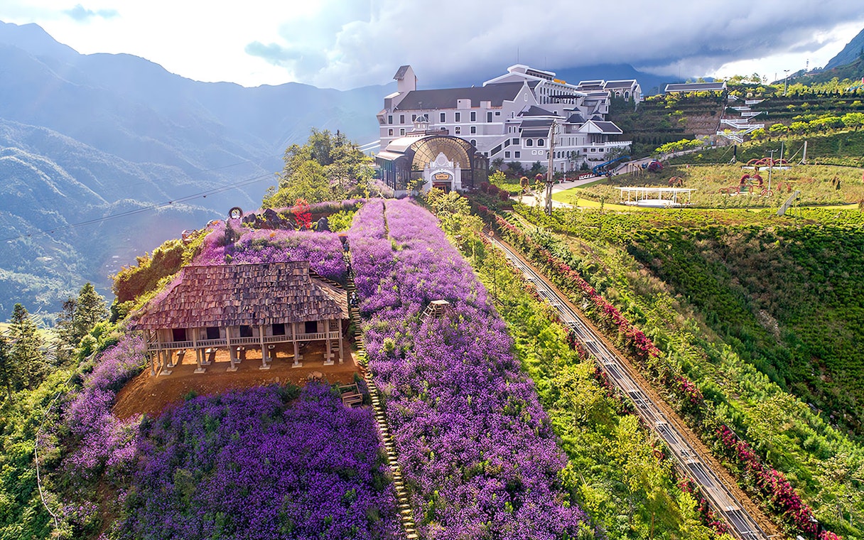 Sun World Fansipan Cable Car station with Muong Hoa Monorail and purple flower fields in Sapa, Vietnam.
