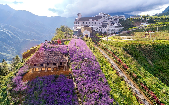 Sun World Fansipan Cable Car station with Muong Hoa Monorail and purple flower fields in Sapa, Vietnam.