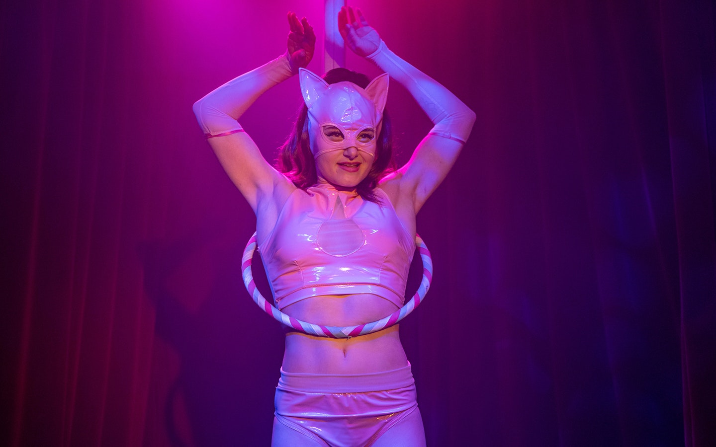 Performer in costume with hula hoop at Miss Behaves: Maverick's Variety Show.