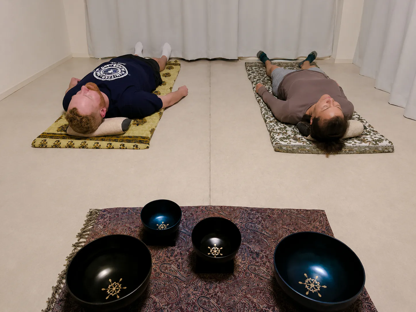 Participants in lying-down meditation with sound bowls, Kyoto.