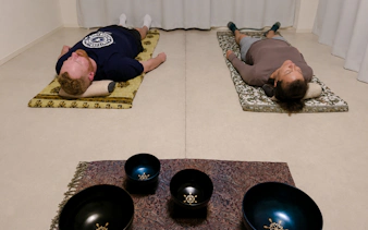 Participants in lying-down meditation with sound bowls, Kyoto.