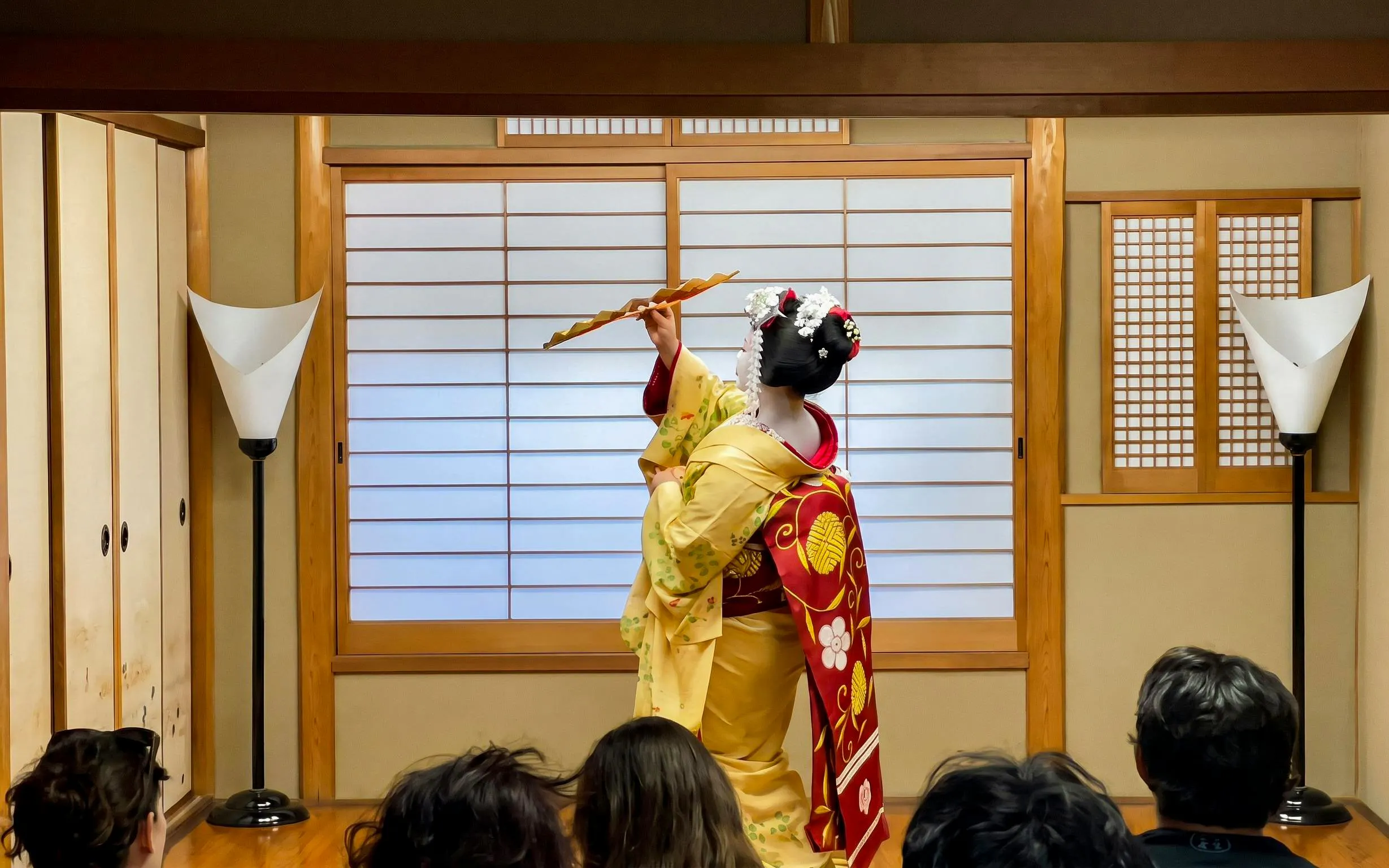 Maiko performing traditional dance in a Kyoto tea house during Gion walking tour.