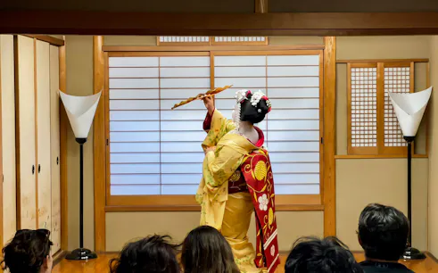 Maiko performing traditional dance in a Kyoto tea house during Gion walking tour.