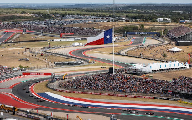 Formula 1 cars racing at Circuit of the Americas, Texas, during USA Grand Prix.