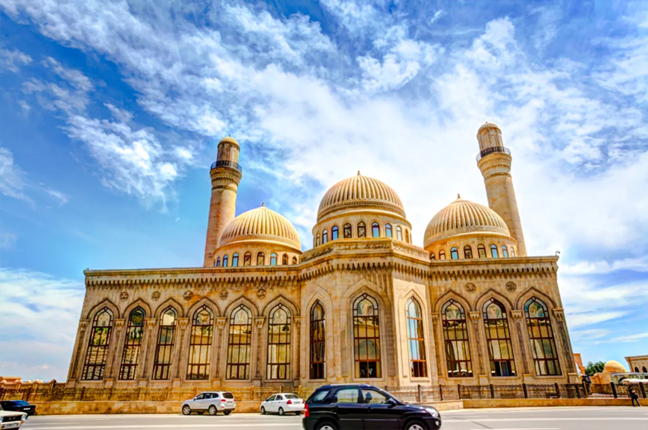 Gobustan mosque with domes and minarets under a blue sky, Baku.