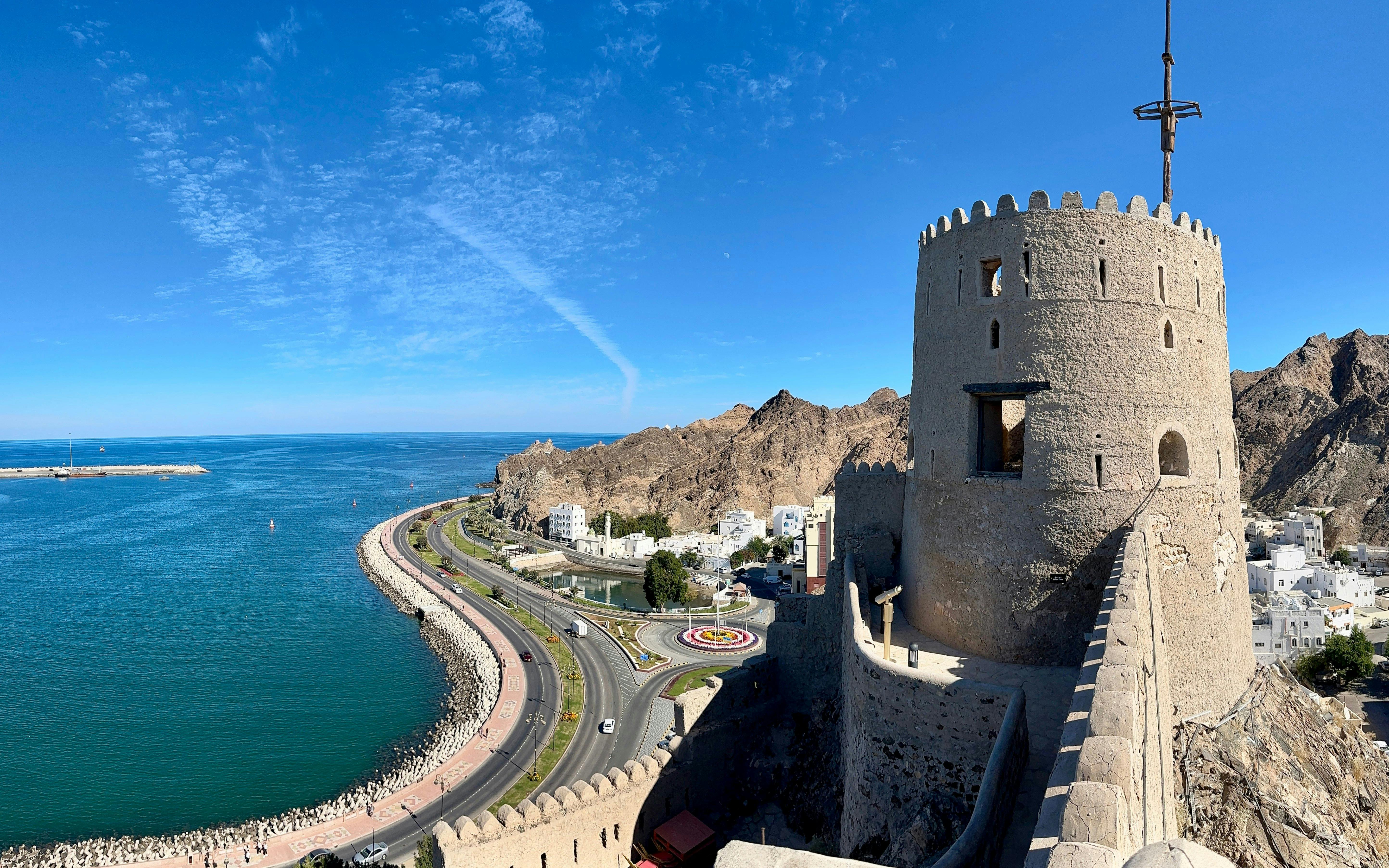 Muttrah Fort overlooking the coastline and mountains in Muscat, Oman.