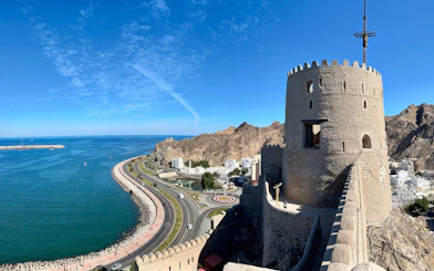 Muttrah Fort overlooking the coastline and mountains in Muscat, Oman.