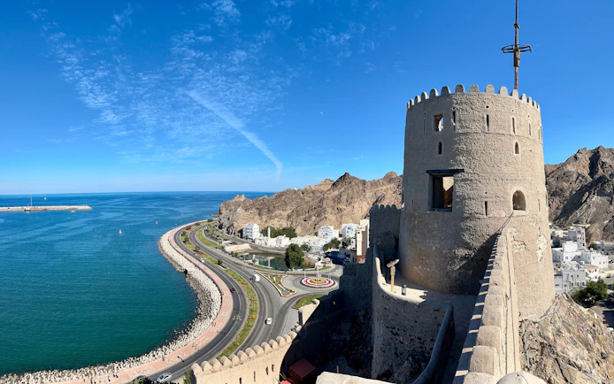 Muttrah Fort overlooking the coastline and mountains in Muscat, Oman.