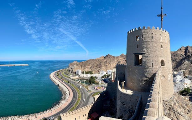 Muttrah Fort overlooking the coastline and mountains in Muscat, Oman.