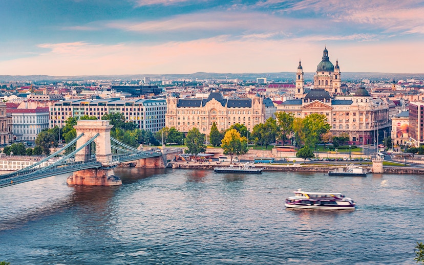 Aerial view of a sightseeing cruise on the Danube River with Budapest cityscape.