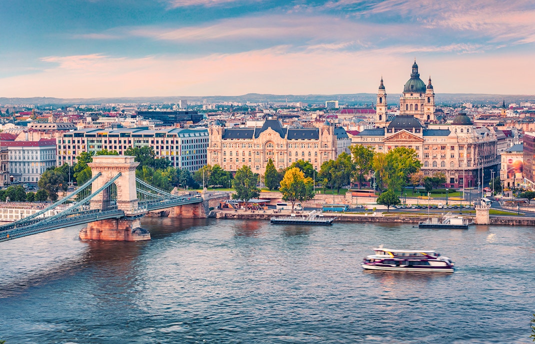 Aerial view of a sightseeing cruise on the Danube River with Budapest cityscape.