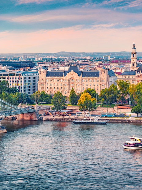 Aerial view of a sightseeing cruise on the Danube River with Budapest cityscape.