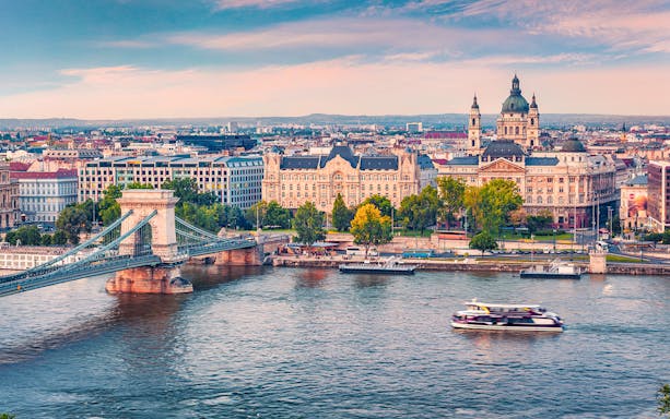 Aerial view of a sightseeing cruise on the Danube River with Budapest cityscape.