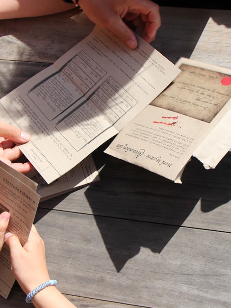 Participants examining clues during a murder mystery at Christiansborg Palace.