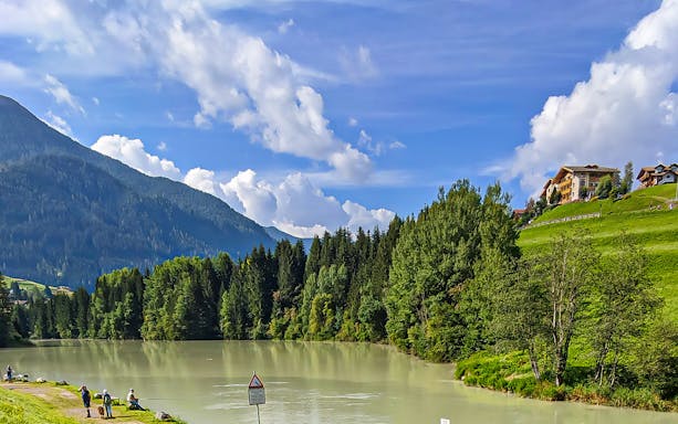 Guided tour view of Dolomites Mountains with lake and forest near Lake Garda.