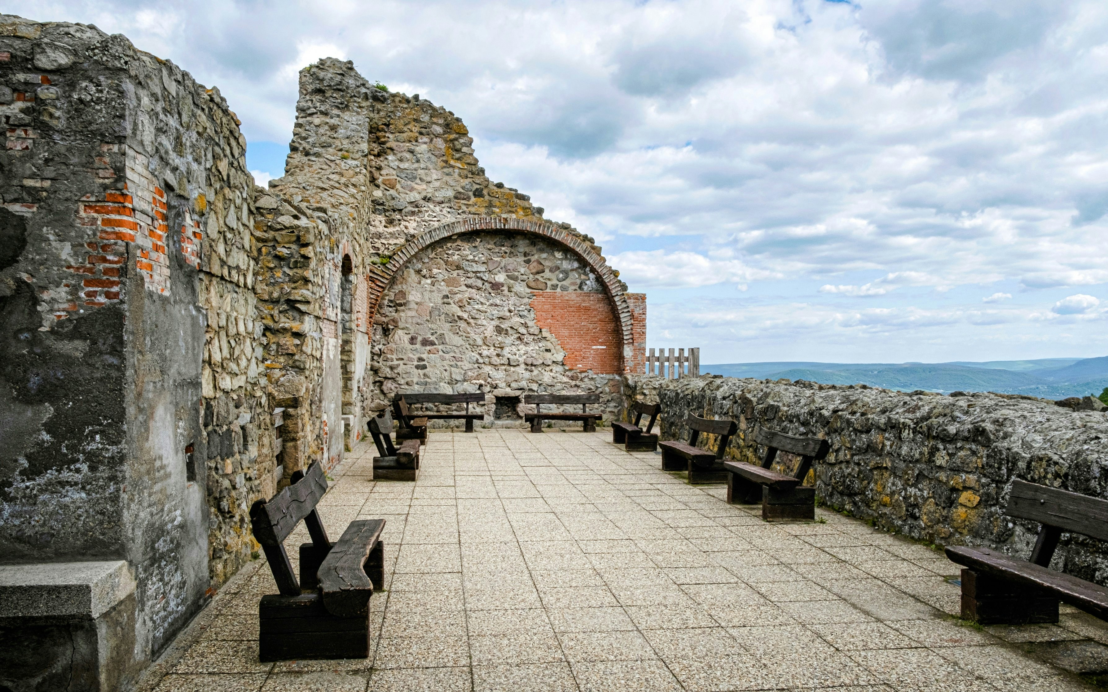 Ruin castle courtyard with stone walls and benches, Visegrad, Hungary.