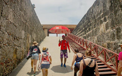Visitors exploring Cartagena's historic city walls on a guided tour.