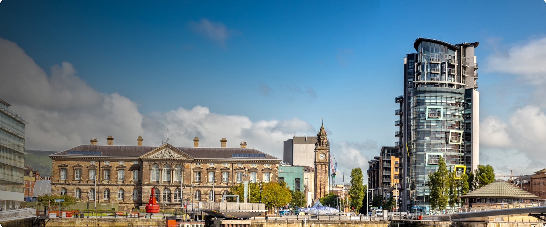 Belfast cityscape with iconic Harland and Wolff cranes in the background.
