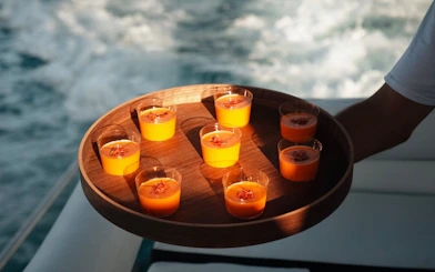 Tray of gazpacho cups served on a Benalmádena sunset cruise.