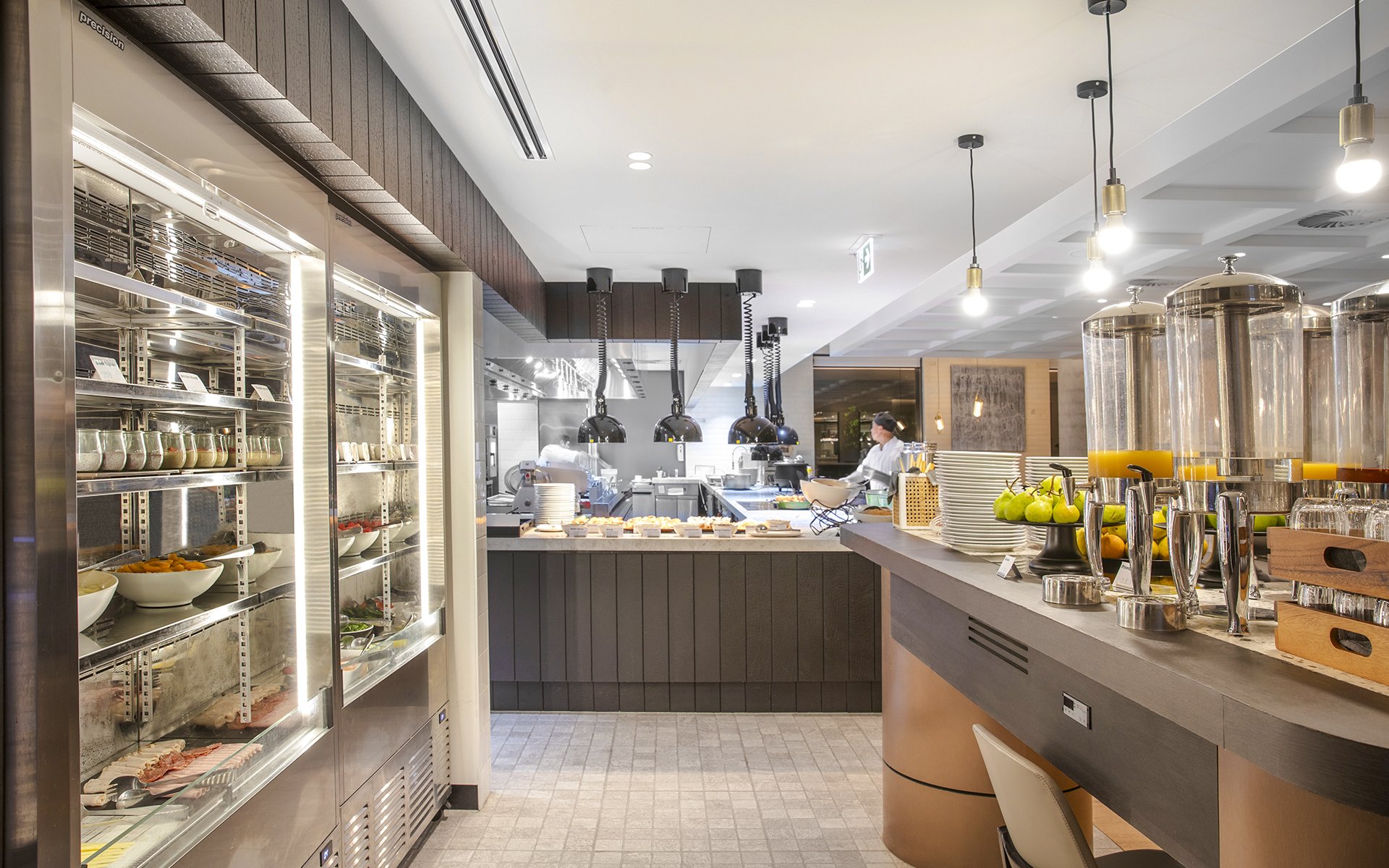 Buffet breakfast area at Holiday Inn & Suites Geelong with fresh fruits and juices.