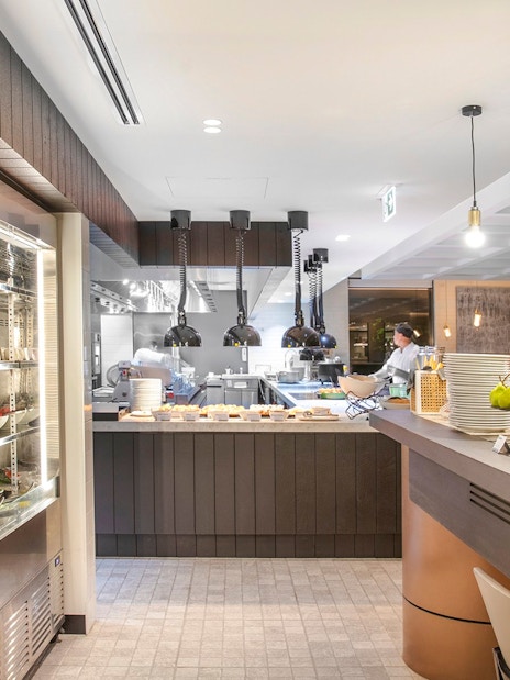 Buffet breakfast area at Holiday Inn & Suites Geelong with fresh fruits and juices.